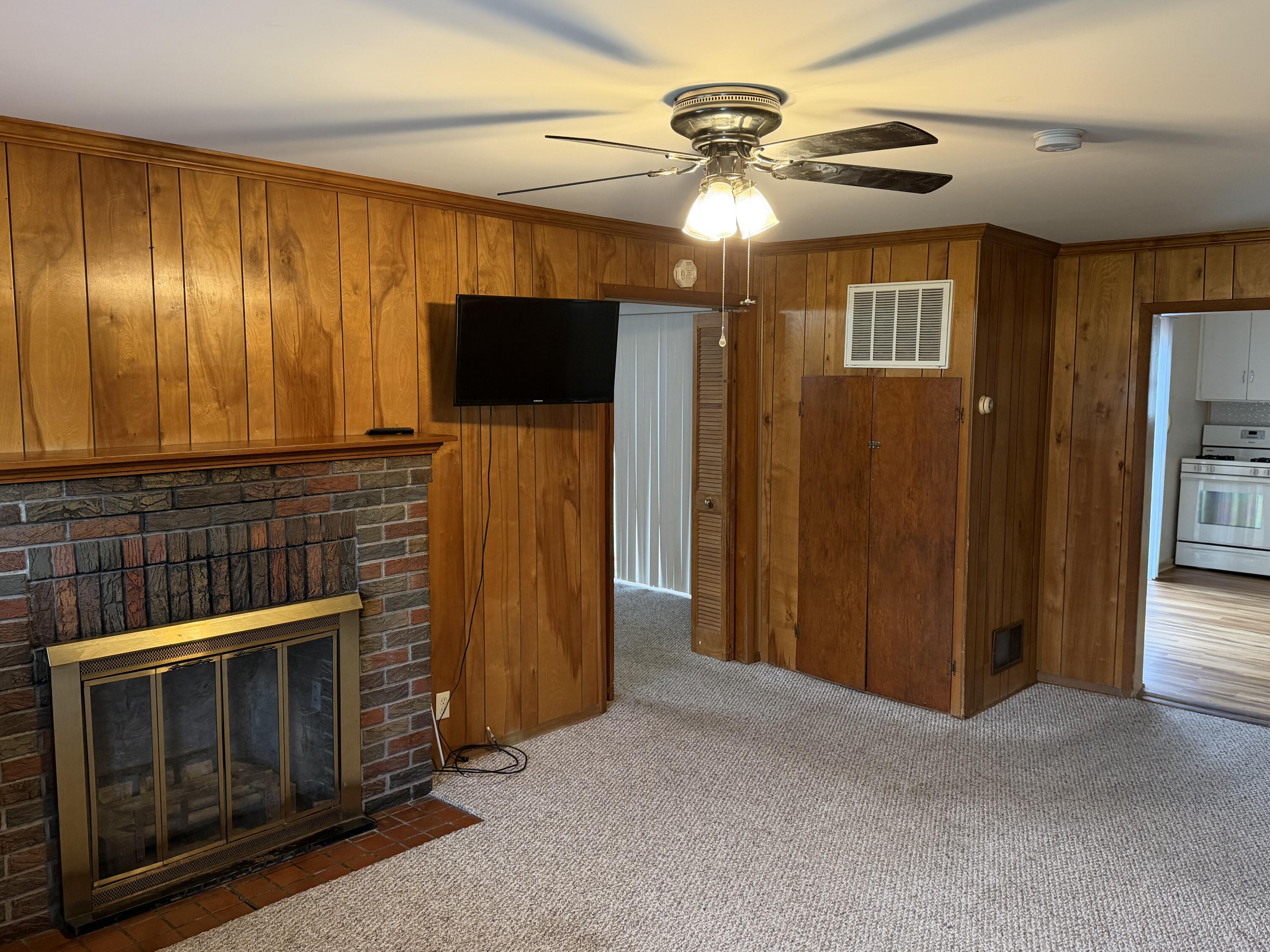 2945 Monnier Street Portage, IN 46368 - Photo 10 of 32 a view of an empty room with a fireplace and a window