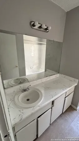 a white toilet sitting next to a white wall