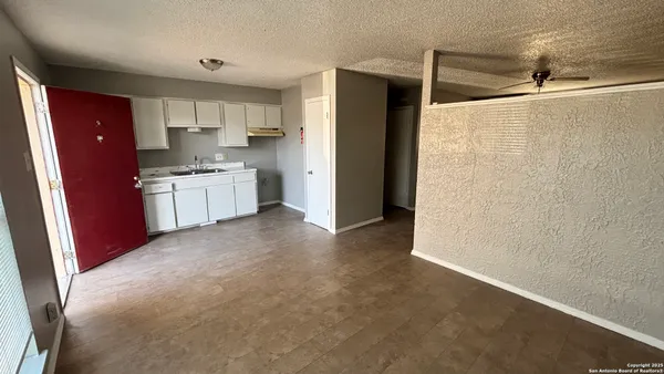 a utility room with wooden floor washer and dryer