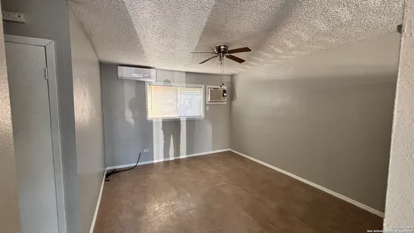 a view of a room with a ceiling fan