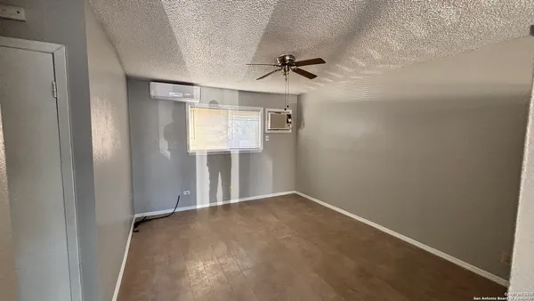 a view of a room with wooden floor