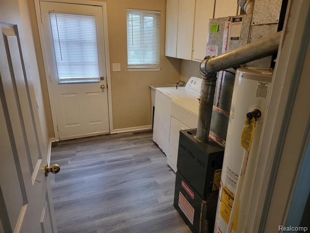 21828 Rausch Avenue Eastpointe, MI 48021 - Photo 8 of 15 Utility space featuring wood-finish flooring, a rear exterior door with window, and built-in upper cabinetry