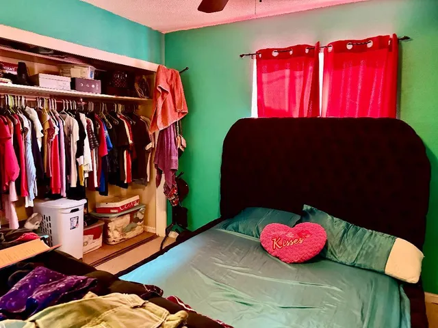 a bedroom with a bed and a window