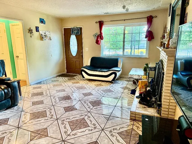 a living room with a bed furniture and a window