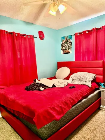 a bedroom with a bed and a lamp