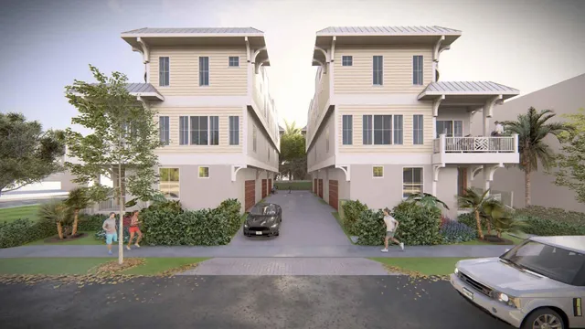 a front view of multiple houses with yard