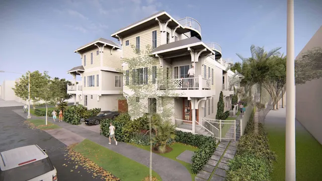 a view of a white house with a small yard and plants