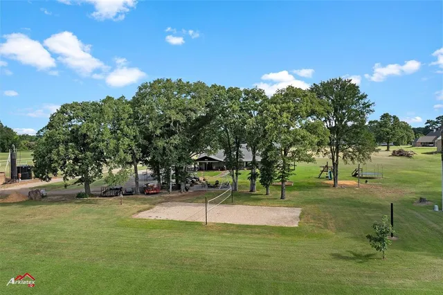 a living room with furniture a fireplace and a large window