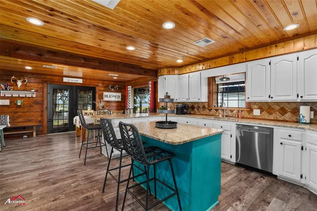 a view of a kitchen with fridge and workspace