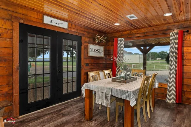 a view of an entryway with wooden floor and door