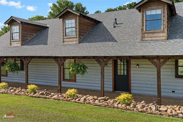 a front view of house with a garden
