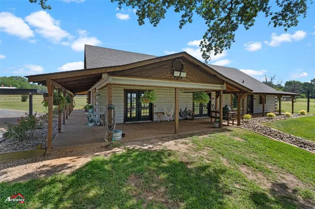 a view of a house with sitting area and garden