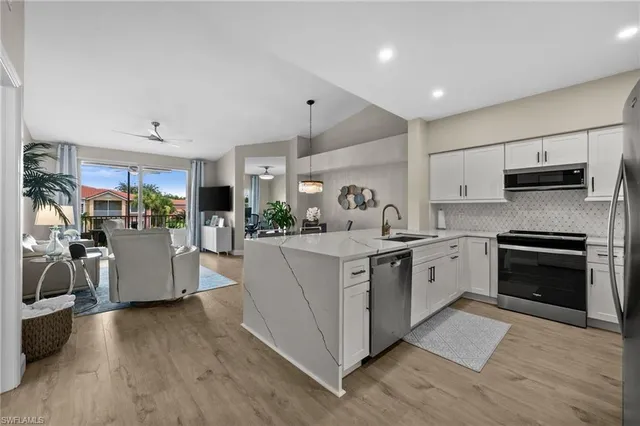 a kitchen with counter top space cabinets and stainless steel appliances