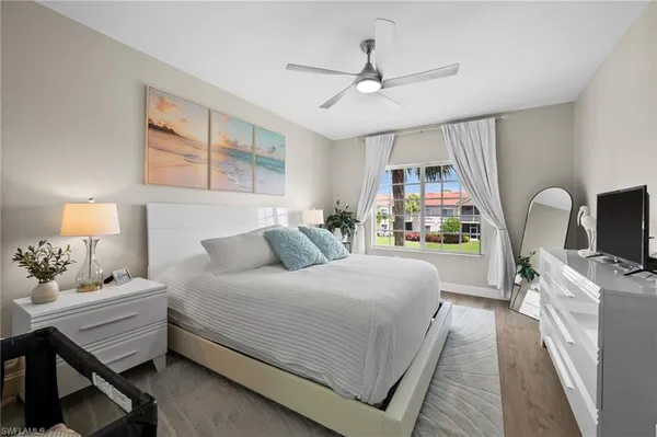 a bedroom with a bed window and couch