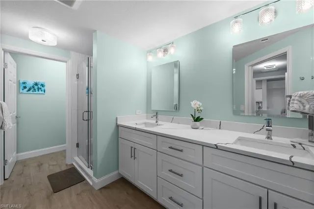 a bathroom with 2 sink tub and a mirror