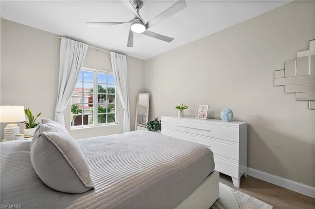 a bedroom with a large bed and a large window