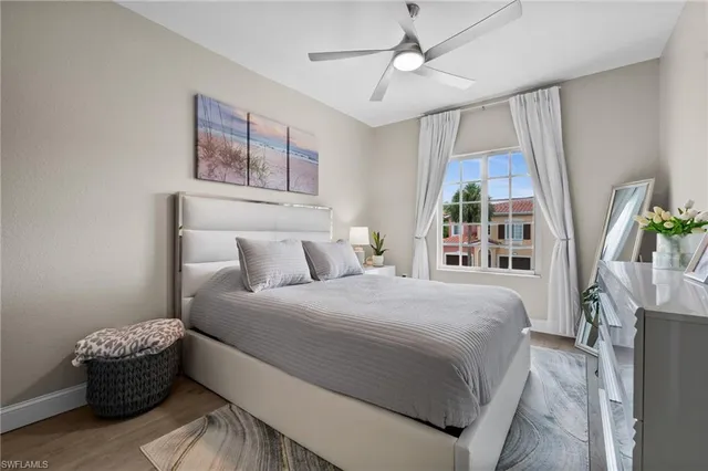 a bedroom with a large bed and a window