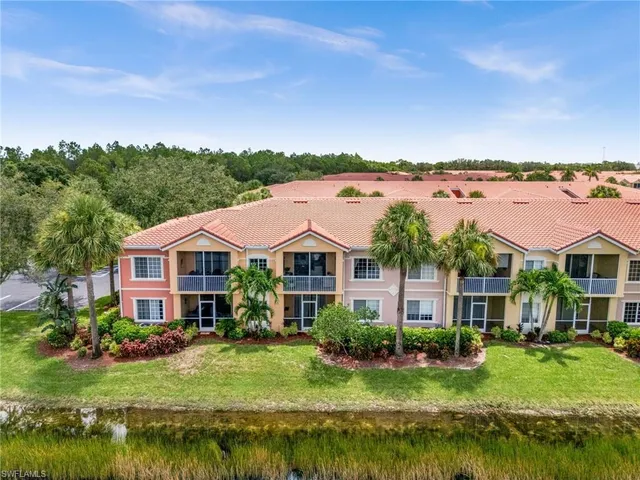a front view of a house with yard and green space