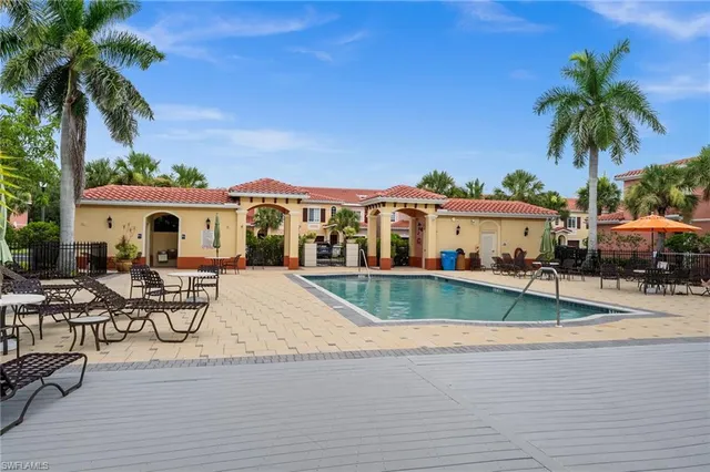 a view of multiple houses with swimming pool