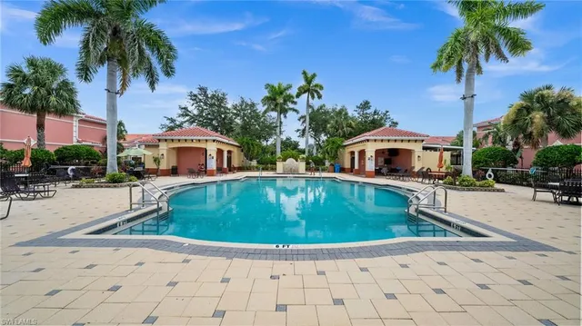 a swimming pool with outdoor seating and yard