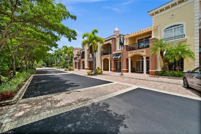 a living room with lots of furniture and kitchen view