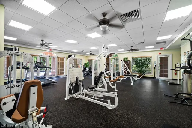 an aerial view of a city with lots of residential buildings ocean and mountain view in back