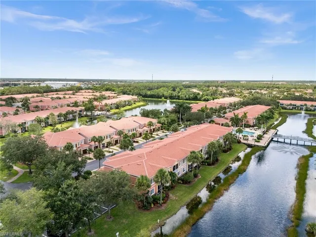 an aerial view of a house with a garden and lake view