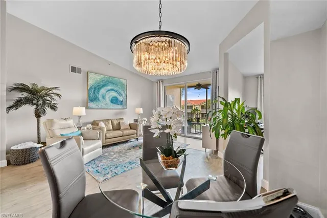 a view of a dining room with furniture and chandelier