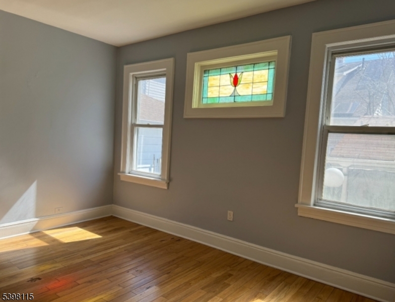 70 Elliot Street, Unit 1 Passaic, NJ 07055 - Photo 12 of 15 a view of empty room with wooden floor and fan