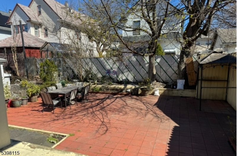 70 Elliot Street, Unit 1 Passaic, NJ 07055 - Photo 14 of 15 a view of a patio with table and chairs and potted plants