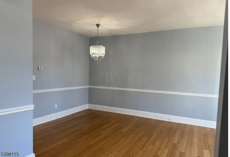 70 Elliot Street, Unit 1 Passaic, NJ 07055 - Photo 6 of 15 a view of an empty room with wooden floor