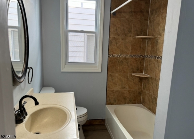70 Elliot Street, Unit 1 Passaic, NJ 07055 - Photo 10 of 15 a bathroom with a sink toilet and shower