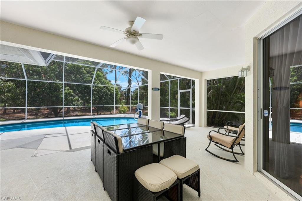 697 Crossfield Circle Naples, FL 34104 - Photo 16 of 20 a living room with furniture and a large window