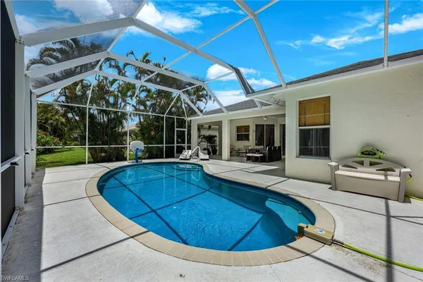 a view of a patio with swimming pool table and chairs