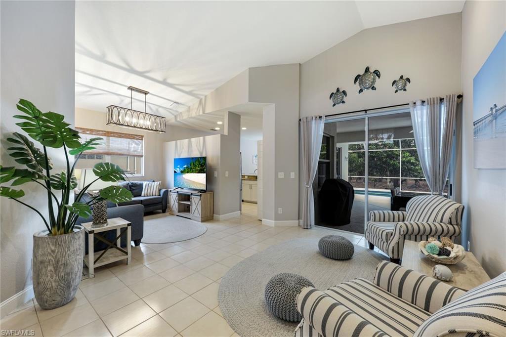 697 Crossfield Circle Naples, FL 34104 - Photo 4 of 20 a living room with furniture flowerpot and a potted plant