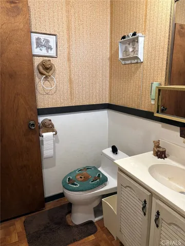 a bathroom with a sink a toilet and a mirror