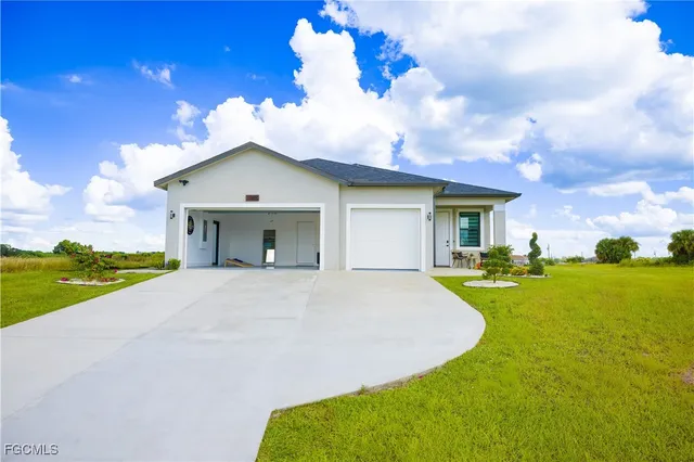 a view of a house with swimming pool and a yard