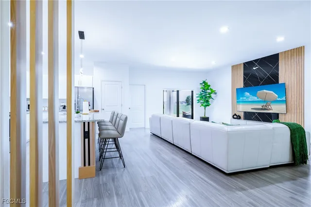 a view of a bedroom with furniture and wooden floor