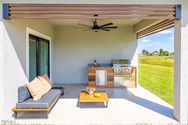 a living room with furniture potted plant and a flat screen tv