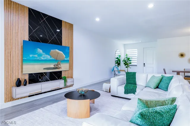 a kitchen view with kitchen island granite countertop a sink and a counter top space