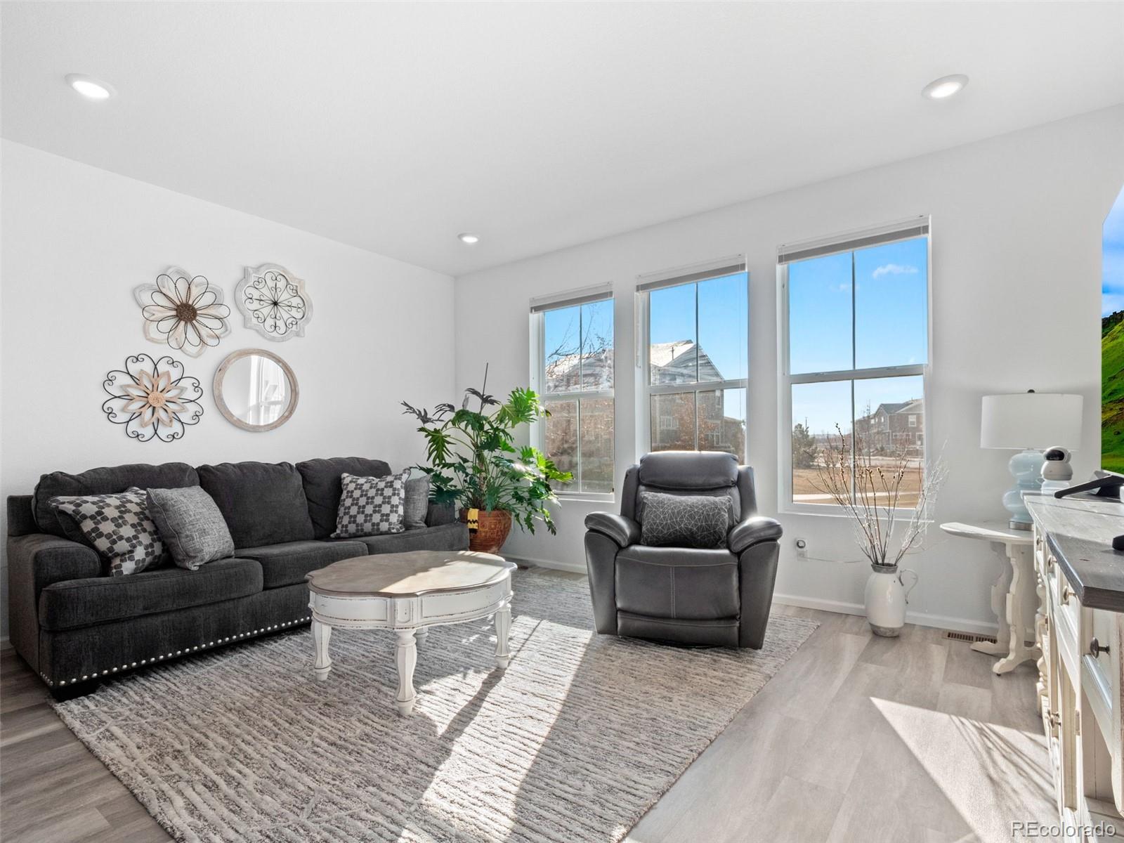 714 Prairie Clover Way Brighton, CO 80640 - Photo 5 of 41 a living room with furniture and a large window