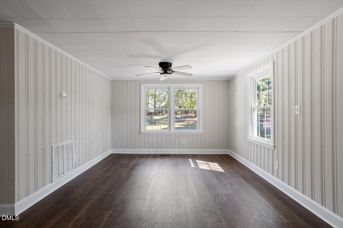2008 Angier Road Fuquay-Varina, NC 27526 - Photo 11 of 34 an empty room with wooden floor and windows