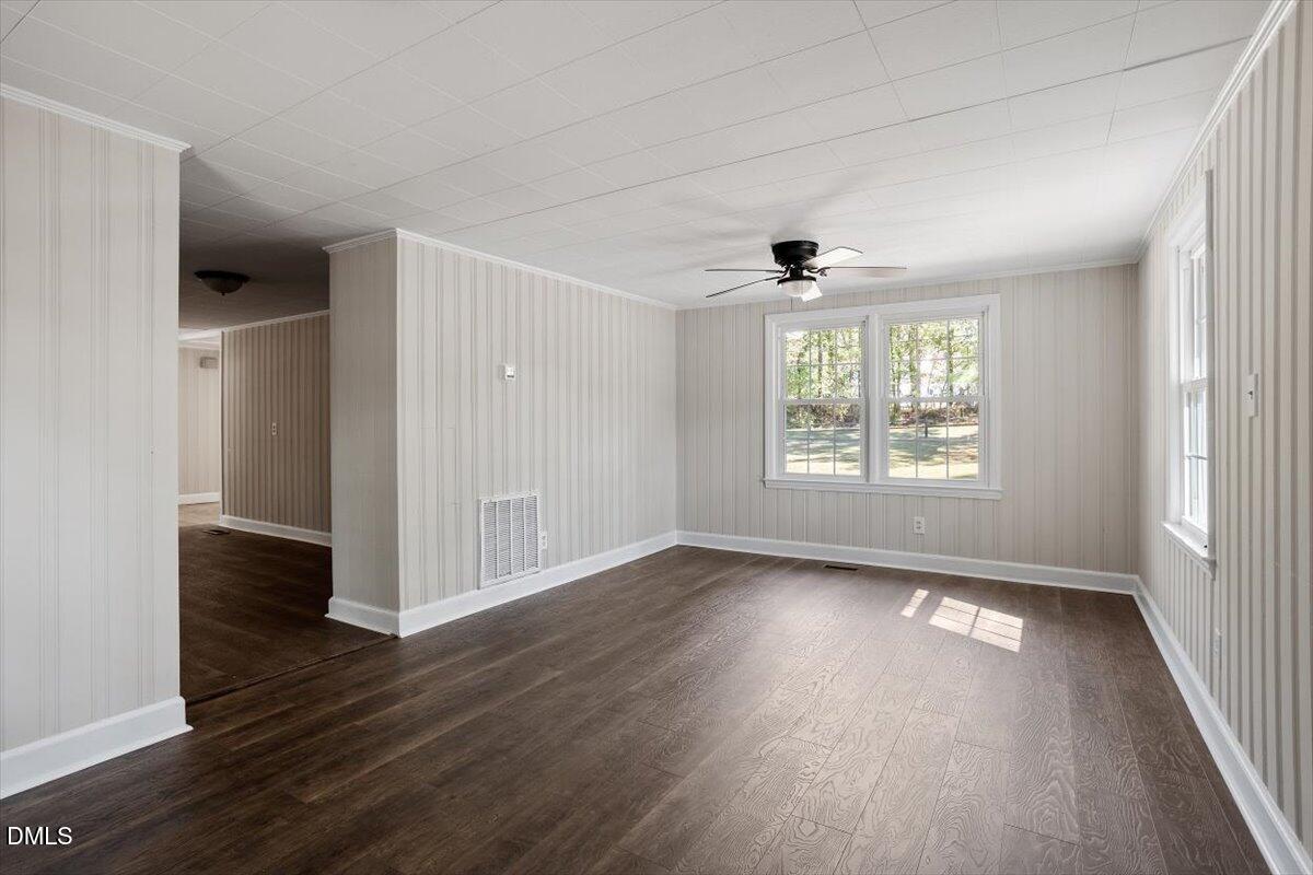 2008 Angier Road Fuquay-Varina, NC 27526 - Photo 12 of 34 an empty room with wooden floor and windows