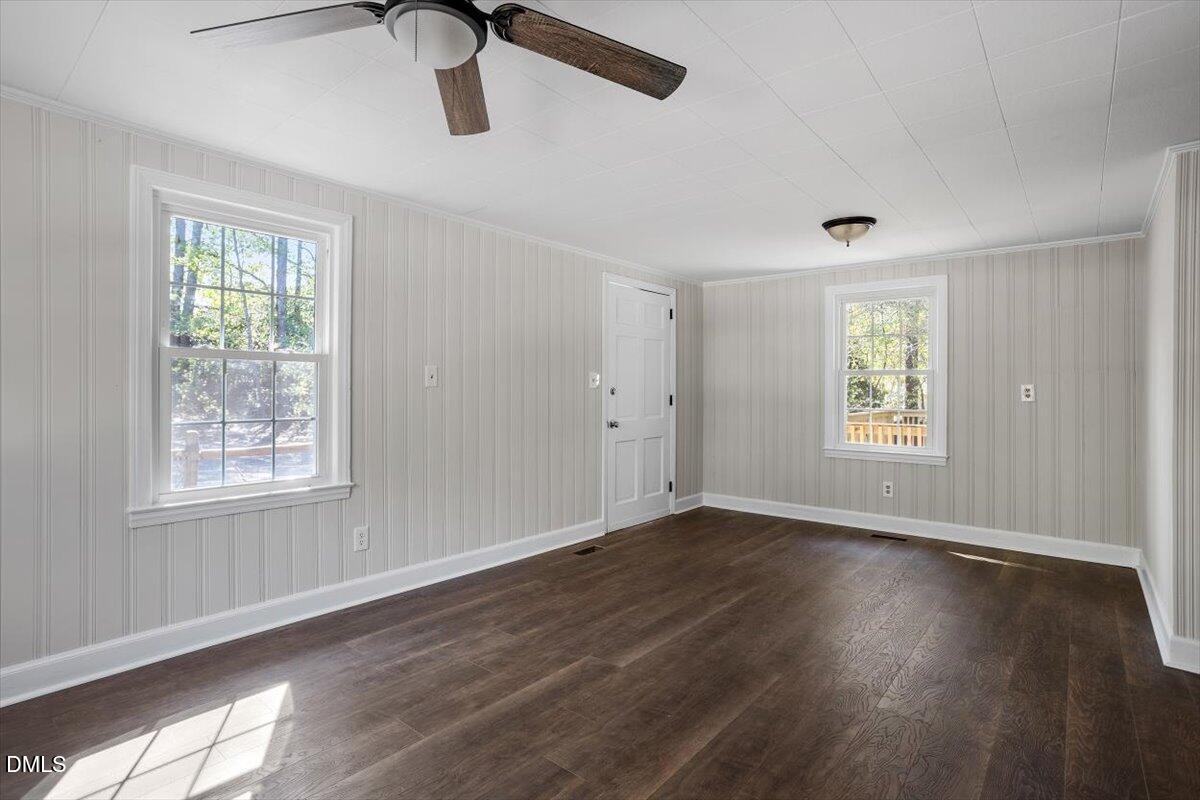 2008 Angier Road Fuquay-Varina, NC 27526 - Photo 14 of 34 a view of an empty room with wooden floor and a window