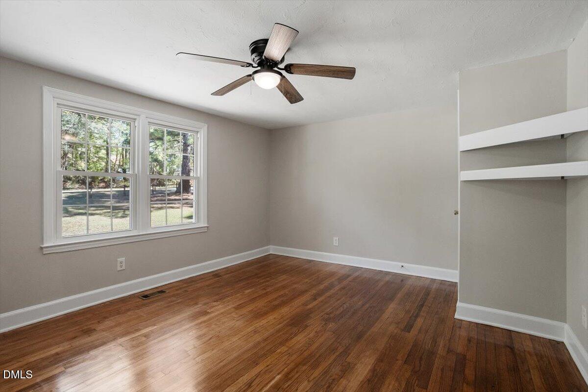 2008 Angier Road Fuquay-Varina, NC 27526 - Photo 21 of 34 a view of an empty room with wooden floor and a window
