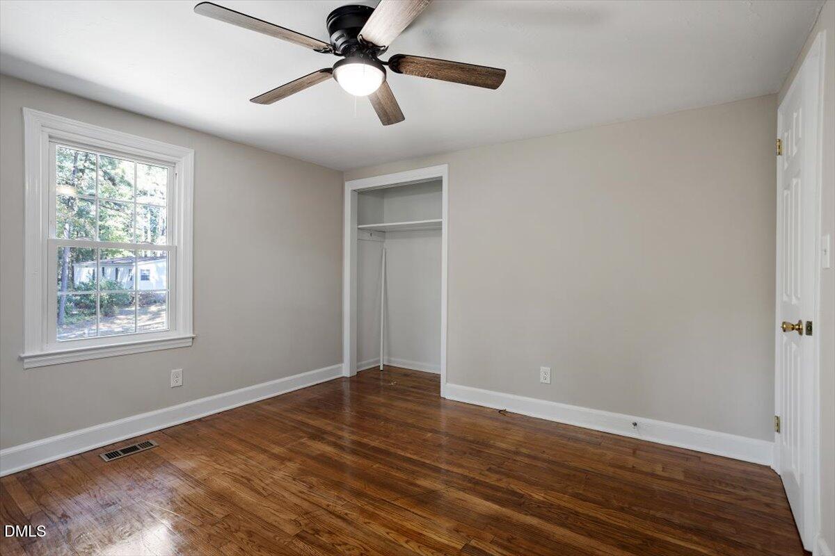 2008 Angier Road Fuquay-Varina, NC 27526 - Photo 23 of 34 a view of an empty room with wooden floor and a window