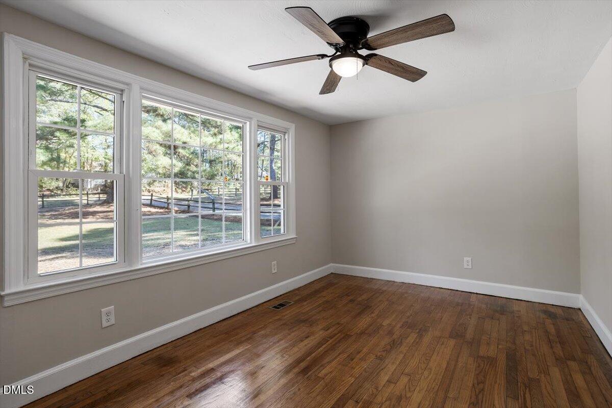 2008 Angier Road Fuquay-Varina, NC 27526 - Photo 24 of 34 a view of empty room with wooden floor and fan