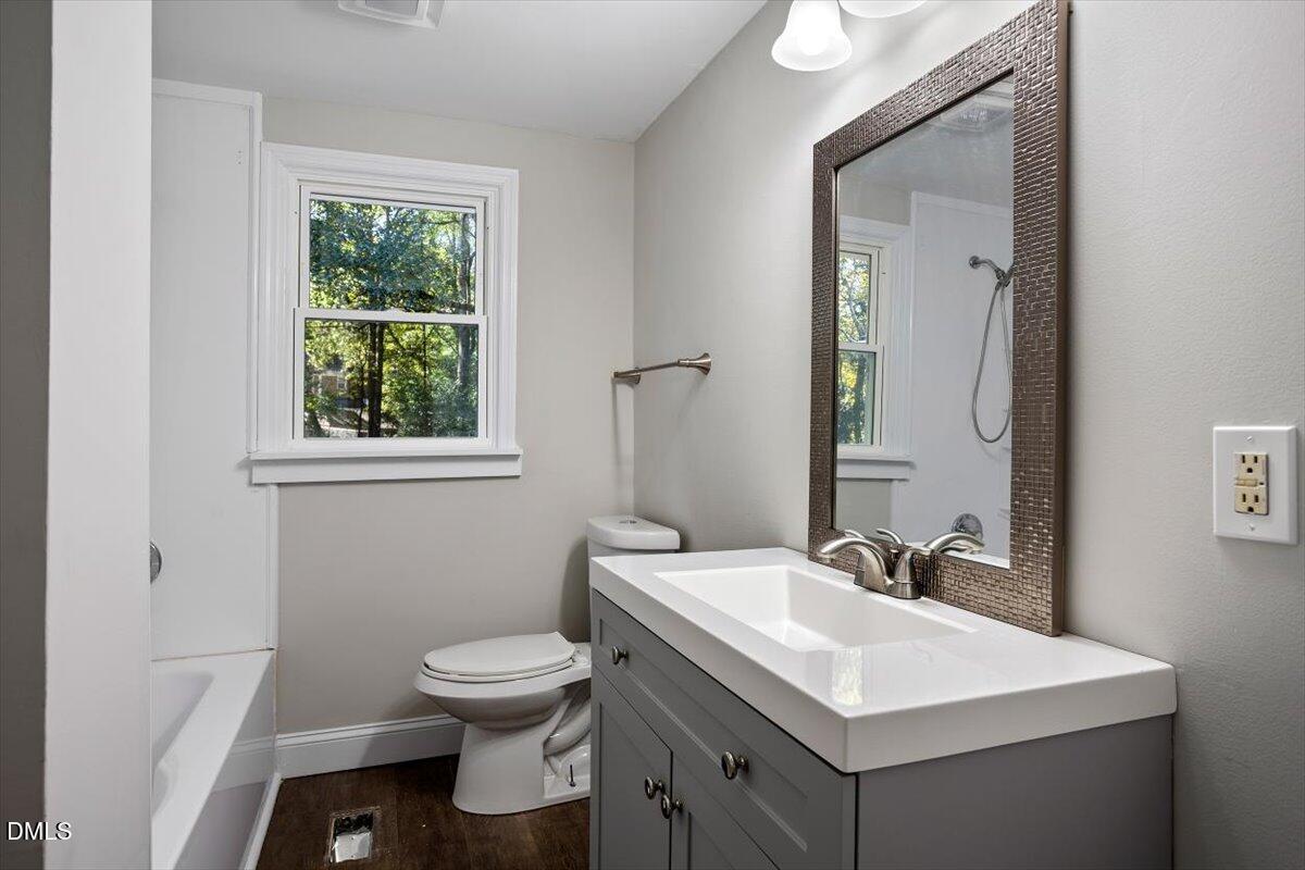 2008 Angier Road Fuquay-Varina, NC 27526 - Photo 25 of 34 a bathroom with a toilet sink and mirror