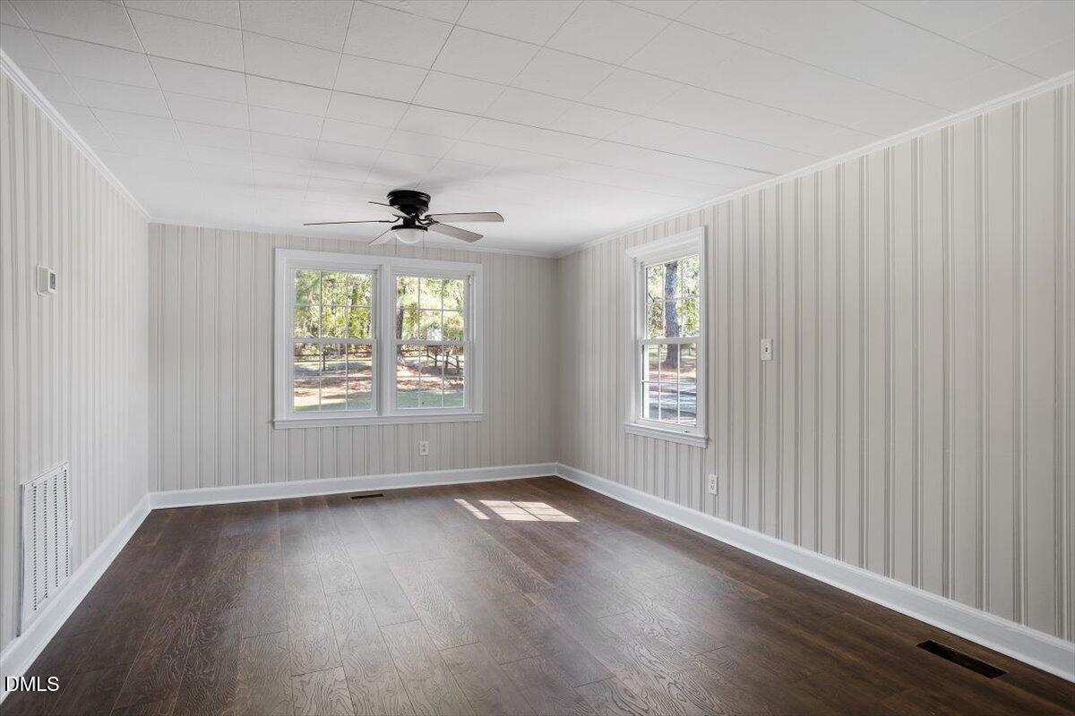 2008 Angier Road Fuquay-Varina, NC 27526 - Photo 10 of 34 an empty room with wooden floor and windows