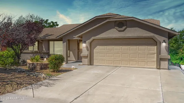 an aerial view of a house with a yard and lake view